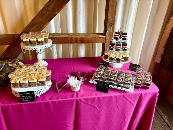 Individual dessert cups displayed on a pink dessert table