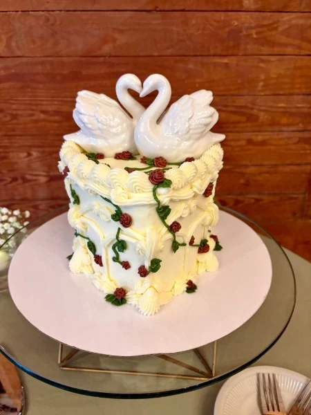 Celebration cake decorated with swans and flowers